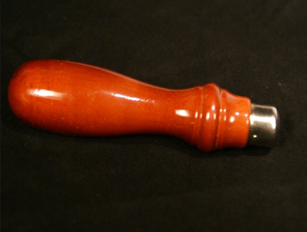 Wooden tool handle with a metal ferrul.